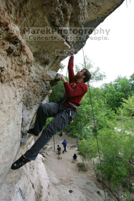 Me top rope climbing Diving for Rocks (5.10d), photographed from  the third bolt of Magster (5.10a) by Andrew Dreher.  It was another long day of rock climbing at Seismic Wall on Austin's Barton Creek Greenbelt, Saturday, April 11, 2009.

Filename: SRM_20090411_17165858.JPG
Aperture: f/5.6
Shutter Speed: 1/320
Body: Canon EOS-1D Mark II
Lens: Canon EF 16-35mm f/2.8 L