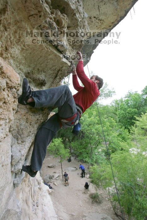 Me top rope climbing Diving for Rocks (5.10d), photographed from  the third bolt of Magster (5.10a) by Andrew Dreher.  It was another long day of rock climbing at Seismic Wall on Austin's Barton Creek Greenbelt, Saturday, April 11, 2009.

Filename: SRM_20090411_17170164.JPG
Aperture: f/5.6
Shutter Speed: 1/320
Body: Canon EOS-1D Mark II
Lens: Canon EF 16-35mm f/2.8 L