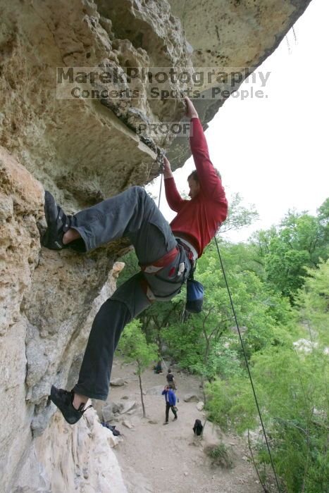 Me top rope climbing Diving for Rocks (5.10d), photographed from  the third bolt of Magster (5.10a) by Andrew Dreher.  It was another long day of rock climbing at Seismic Wall on Austin's Barton Creek Greenbelt, Saturday, April 11, 2009.

Filename: SRM_20090411_17170869.JPG
Aperture: f/5.6
Shutter Speed: 1/320
Body: Canon EOS-1D Mark II
Lens: Canon EF 16-35mm f/2.8 L