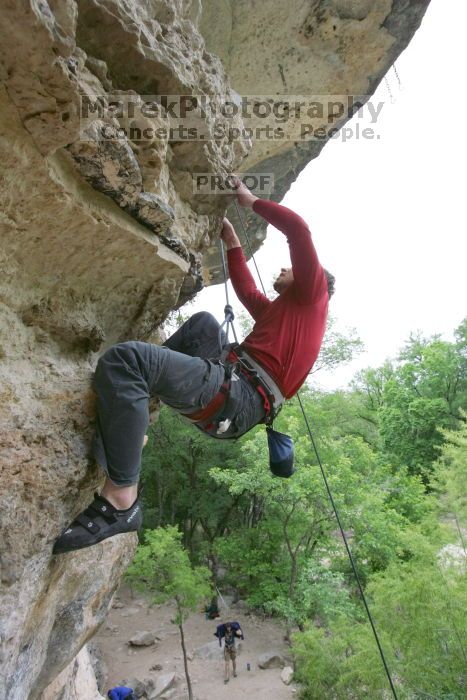 Me top rope climbing Diving for Rocks (5.10d), photographed from  the third bolt of Magster (5.10a) by Andrew Dreher.  It was another long day of rock climbing at Seismic Wall on Austin's Barton Creek Greenbelt, Saturday, April 11, 2009.

Filename: SRM_20090411_17171371.JPG
Aperture: f/5.6
Shutter Speed: 1/320
Body: Canon EOS-1D Mark II
Lens: Canon EF 16-35mm f/2.8 L