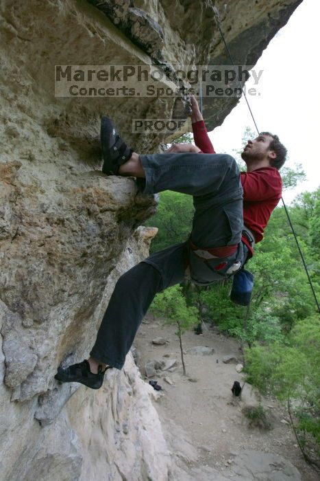 Me top rope climbing Diving for Rocks (5.10d), photographed from  the third bolt of Magster (5.10a) by Andrew Dreher.  It was another long day of rock climbing at Seismic Wall on Austin's Barton Creek Greenbelt, Saturday, April 11, 2009.

Filename: SRM_20090411_17185678.JPG
Aperture: f/5.6
Shutter Speed: 1/320
Body: Canon EOS-1D Mark II
Lens: Canon EF 16-35mm f/2.8 L