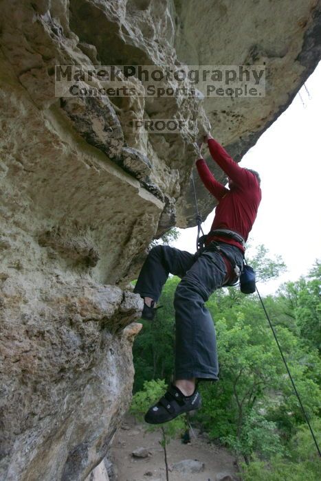 Me top rope climbing Diving for Rocks (5.10d), photographed from  the third bolt of Magster (5.10a) by Andrew Dreher.  It was another long day of rock climbing at Seismic Wall on Austin's Barton Creek Greenbelt, Saturday, April 11, 2009.

Filename: SRM_20090411_17190281.JPG
Aperture: f/5.6
Shutter Speed: 1/320
Body: Canon EOS-1D Mark II
Lens: Canon EF 16-35mm f/2.8 L