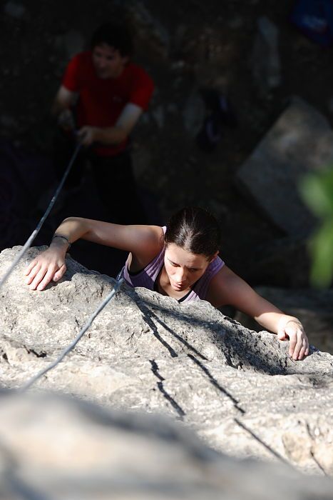 Beth Marek top rope climbing Roo Dog (5.8) with Andrew Dreher belaying, taken from the anchors of the route.  It was Beth's third time outside, and another long day of rock climbing at Seismic Wall on Austin's Barton Creek Greenbelt, Monday, May 25, 2009.

Filename: SRM_20090525_09420100.JPG
Aperture: f/4.0
Shutter Speed: 1/1000
Body: Canon EOS-1D Mark II
Lens: Canon EF 80-200mm f/2.8 L