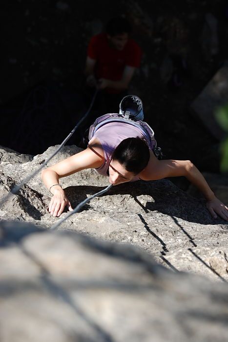 Beth Marek top rope climbing Roo Dog (5.8) with Andrew Dreher belaying, taken from the anchors of the route.  It was Beth's third time outside, and another long day of rock climbing at Seismic Wall on Austin's Barton Creek Greenbelt, Monday, May 25, 2009.

Filename: SRM_20090525_09422601.JPG
Aperture: f/4.0
Shutter Speed: 1/1600
Body: Canon EOS-1D Mark II
Lens: Canon EF 80-200mm f/2.8 L