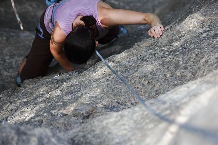 Beth Marek top rope climbing Hollywood (5.7), taken from the anchors of the route.  It was Beth's third time outside, and another long day of rock climbing at Seismic Wall on Austin's Barton Creek Greenbelt, Monday, May 25, 2009.

Filename: SRM_20090525_10391532.JPG
Aperture: f/4.0
Shutter Speed: 1/500
Body: Canon EOS-1D Mark II
Lens: Canon EF 80-200mm f/2.8 L