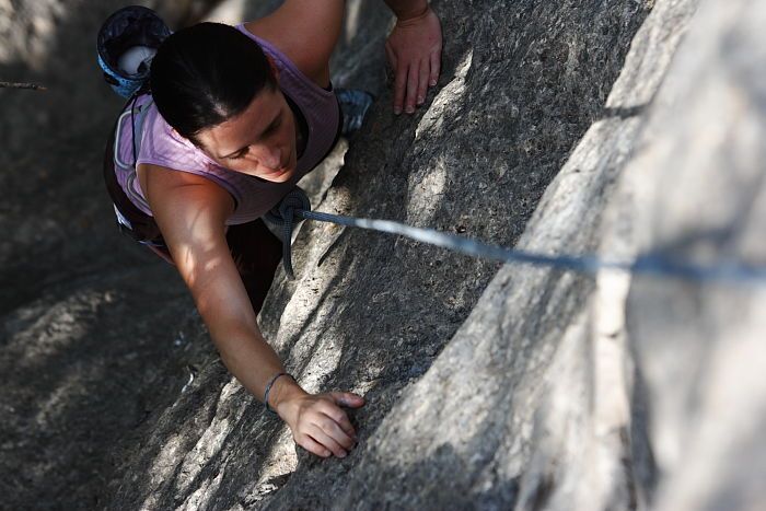 Beth Marek top rope climbing Hollywood (5.7), taken from the anchors of the route.  It was Beth's third time outside, and another long day of rock climbing at Seismic Wall on Austin's Barton Creek Greenbelt, Monday, May 25, 2009.

Filename: SRM_20090525_10393143.JPG
Aperture: f/5.6
Shutter Speed: 1/640
Body: Canon EOS-1D Mark II
Lens: Canon EF 80-200mm f/2.8 L