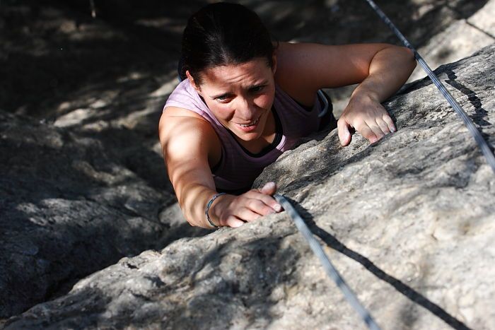 Beth Marek top rope climbing Hollywood (5.7), taken from the anchors of the route.  It was Beth's third time outside, and another long day of rock climbing at Seismic Wall on Austin's Barton Creek Greenbelt, Monday, May 25, 2009.

Filename: SRM_20090525_10414296.JPG
Aperture: f/5.6
Shutter Speed: 1/1250
Body: Canon EOS-1D Mark II
Lens: Canon EF 80-200mm f/2.8 L