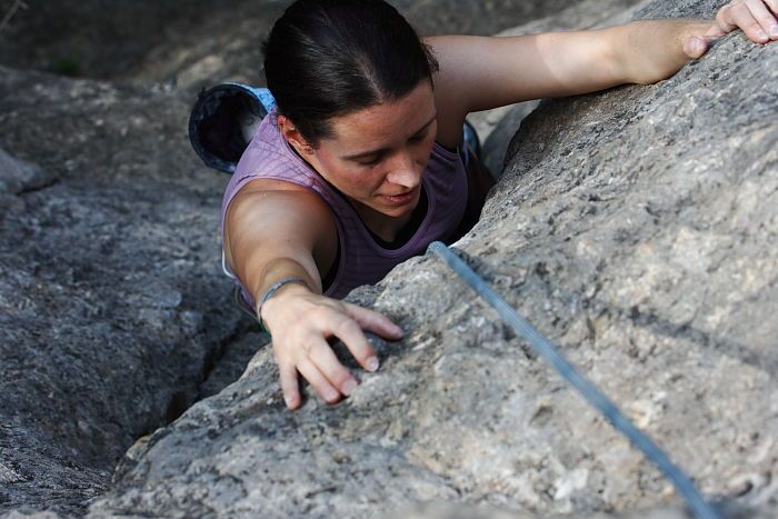 Beth Marek top rope climbing Hollywood (5.7), taken from the anchors of the route.  It was Beth's third time outside, and another long day of rock climbing at Seismic Wall on Austin's Barton Creek Greenbelt, Monday, May 25, 2009.

Filename: SRM_20090525_10423008.JPG
Aperture: f/5.6
Shutter Speed: 1/500
Body: Canon EOS-1D Mark II
Lens: Canon EF 80-200mm f/2.8 L