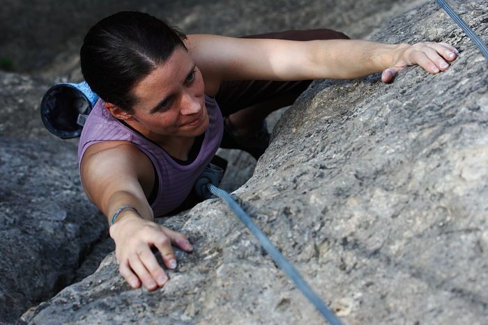 Beth Marek top rope climbing Hollywood (5.7), taken from the anchors of the route.  It was Beth's third time outside, and another long day of rock climbing at Seismic Wall on Austin's Barton Creek Greenbelt, Monday, May 25, 2009.

Filename: SRM_20090525_10423411.JPG
Aperture: f/5.6
Shutter Speed: 1/500
Body: Canon EOS-1D Mark II
Lens: Canon EF 80-200mm f/2.8 L