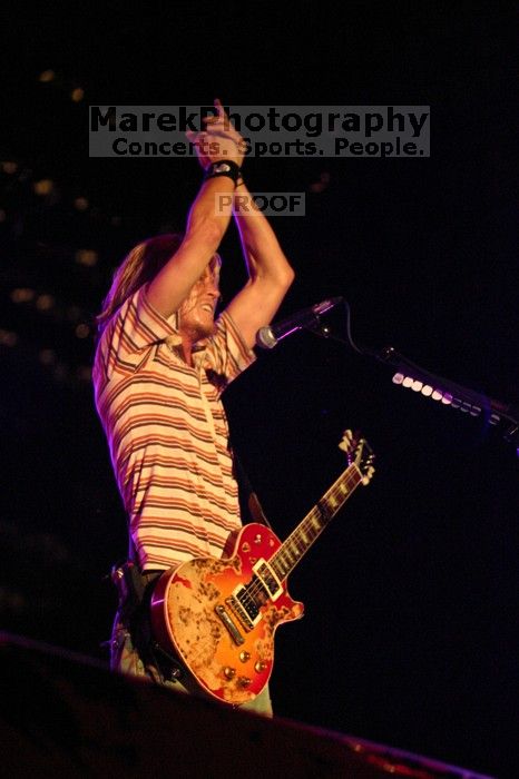 Puddle of Mudd performs on the 99X stage on the first day of Music Midtown, 2004.

Filename: IMG_6100.jpg
Aperture: f/2.8
Shutter Speed: 1/200
Body: Canon EOS DIGITAL REBEL
Lens: Canon EF 80-200mm f/2.8 L