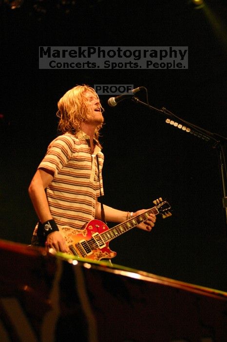 Puddle of Mudd performs on the first day of Music Midtown, 2004.

Filename: IMG_6056.jpg
Aperture: f/2.8
Shutter Speed: 1/160
Body: Canon EOS DIGITAL REBEL
Lens: Canon EF 80-200mm f/2.8 L