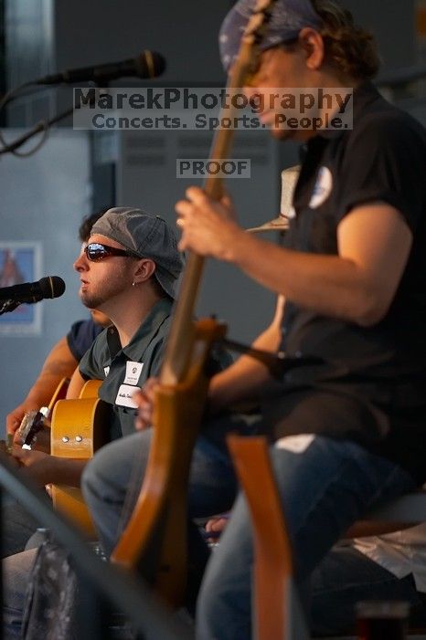 The Gene Pool, performing at the Austin airport.  Geno Stroia II on vocals/guitar, Jorge Castillo on vocals/guitar, Travis Woodard on drums and Steven Ray Will on vocals/bass guitar.

Filename: SRM_20060518_154804_8.jpg
Aperture: f/2.8
Shutter Speed: 1/200
Body: Canon EOS 20D
Lens: Canon EF 80-200mm f/2.8 L