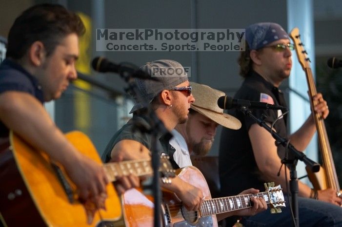 The Gene Pool, performing at the Austin airport.  Geno Stroia II on vocals/guitar, Jorge Castillo on vocals/guitar, Travis Woodard on drums and Steven Ray Will on vocals/bass guitar.

Filename: SRM_20060518_155010_6.jpg
Aperture: f/2.8
Shutter Speed: 1/200
Body: Canon EOS 20D
Lens: Canon EF 80-200mm f/2.8 L