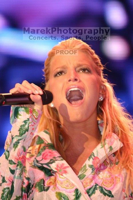 Jessica Simpson performs on the third day of Music Midtown, 2004.

Filename: IMG_7357.jpg
Aperture: f/2.8
Shutter Speed: 1/250
Body: Canon EOS DIGITAL REBEL
Lens: Canon EF 80-200mm f/2.8 L