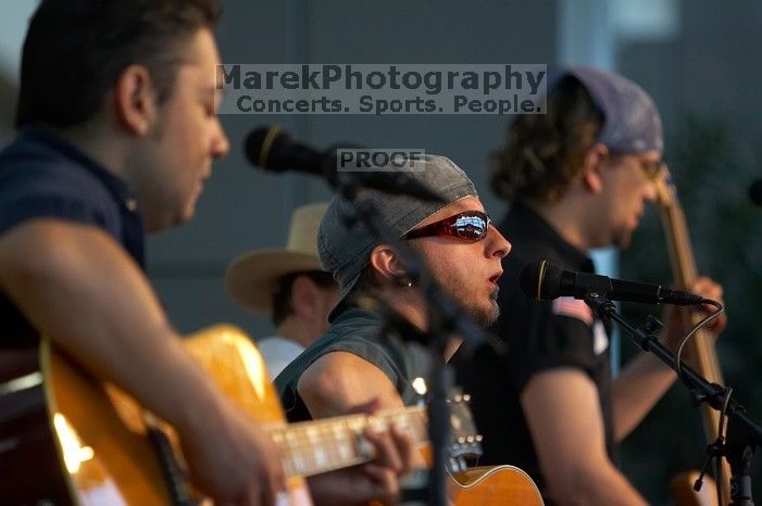 The Gene Pool, performing at the Austin airport.  Geno Stroia II on vocals/guitar, Jorge Castillo on vocals/guitar, Travis Woodard on drums and Steven Ray Will on vocals/bass guitar.

Filename: SRM_20060518_155048_8.jpg
Aperture: f/2.8
Shutter Speed: 1/200
Body: Canon EOS 20D
Lens: Canon EF 80-200mm f/2.8 L