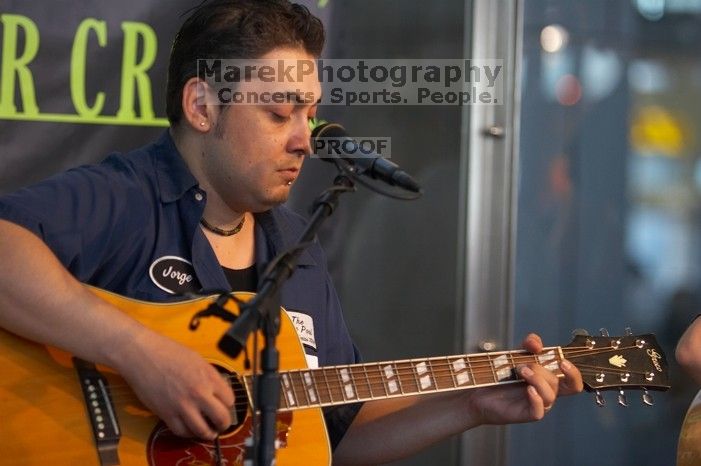 The Gene Pool, performing at the Austin airport.  Geno Stroia II on vocals/guitar, Jorge Castillo on vocals/guitar, Travis Woodard on drums and Steven Ray Will on vocals/bass guitar.

Filename: SRM_20060518_152316_5.jpg
Aperture: f/2.8
Shutter Speed: 1/200
Body: Canon EOS 20D
Lens: Canon EF 80-200mm f/2.8 L