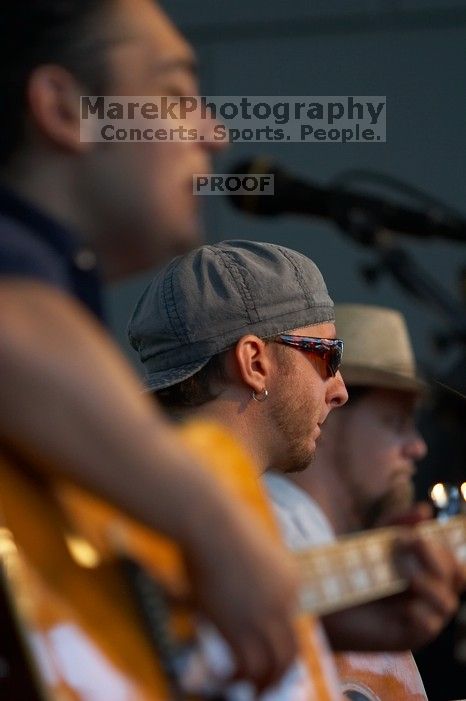 The Gene Pool, performing at the Austin airport.  Geno Stroia II on vocals/guitar, Jorge Castillo on vocals/guitar, Travis Woodard on drums and Steven Ray Will on vocals/bass guitar.

Filename: SRM_20060518_155500_4.jpg
Aperture: f/2.8
Shutter Speed: 1/250
Body: Canon EOS 20D
Lens: Canon EF 80-200mm f/2.8 L